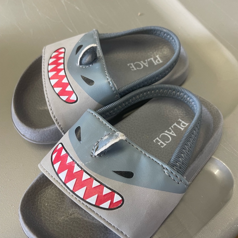 Children’s place shark sandal. Worn on fins, otherwise clean and good condition.